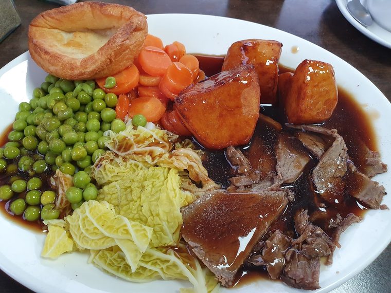 Roast dinner with sliced beef and gravy